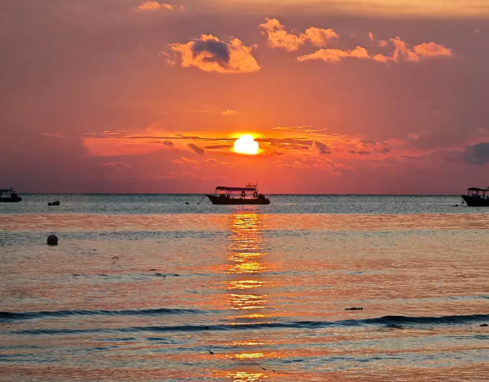 Enchanting Tioman Sea Sunset Long Sunrays Reflecting on the Water with a Boat Silhouette