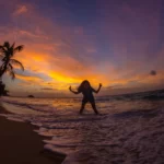 Sunset Bliss on Tioman Island A Girl Splashing Water by the Beach